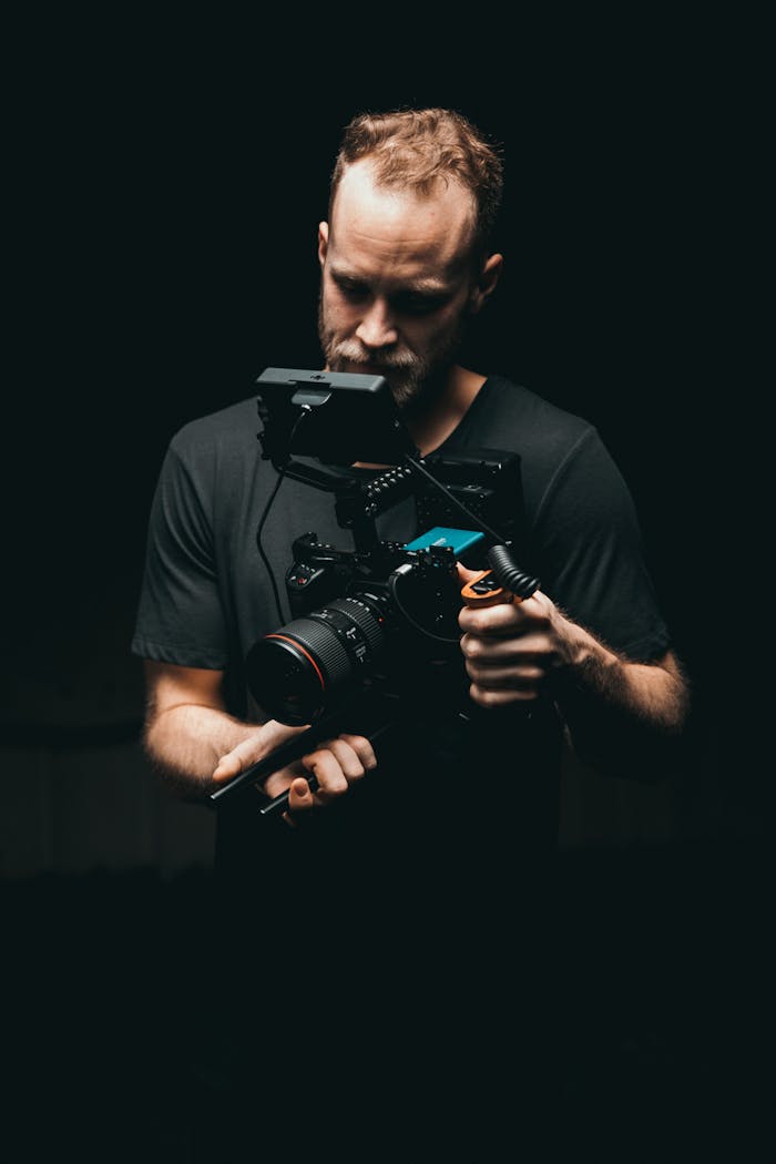 The Art of Drawing Readers In: Your attractive post title goes here A cinematographer adjusts a camera rig with precision, ready for the next scene.